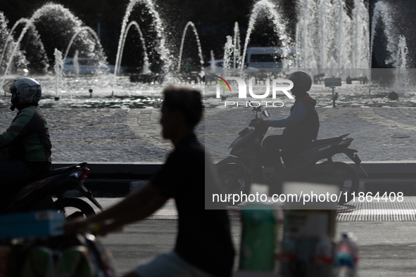 A rider crosses the road during clear weather in Jakarta, Indonesia, on December 12, 2024. The Regional Disaster Management Agency (BPBD) of...