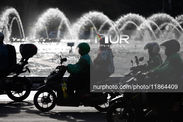 A rider crosses the road during clear weather in Jakarta, Indonesia, on December 12, 2024. The Regional Disaster Management Agency (BPBD) of...