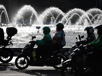 A rider crosses the road during clear weather in Jakarta, Indonesia, on December 12, 2024. The Regional Disaster Management Agency (BPBD) of...