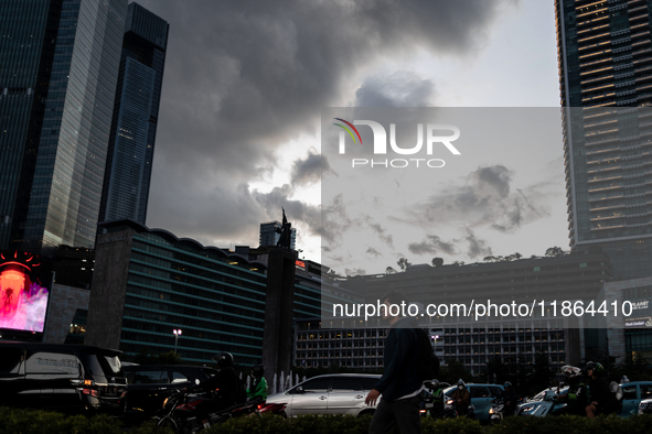 People cross the road following weather modification in Jakarta, Indonesia, on December 12, 2024. The Regional Disaster Management Agency (B...