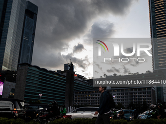 People cross the road following weather modification in Jakarta, Indonesia, on December 12, 2024. The Regional Disaster Management Agency (B...