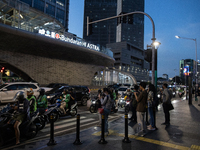 People walk in the business district of Jakarta, Indonesia, on December 12, 2024, during clear weather as evening approaches. The Regional D...