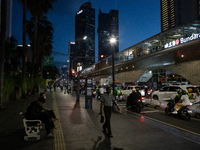 People walk in the business district of Jakarta, Indonesia, on December 12, 2024, during clear weather as evening approaches. The Regional D...