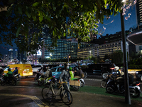 People walk in the business district of Jakarta, Indonesia, on December 12, 2024, during clear weather as evening approaches. The Regional D...