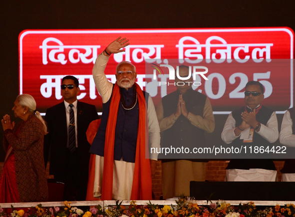 Indian Prime Minister Narendra Modi gestures during a public meeting ahead of the Maha Kumbh Mela festival along the banks of Sangam, the co...