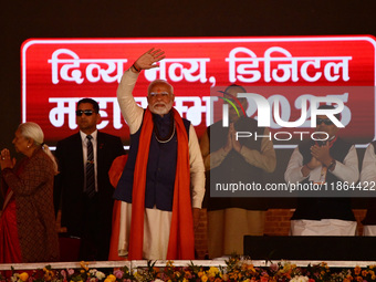 Indian Prime Minister Narendra Modi gestures during a public meeting ahead of the Maha Kumbh Mela festival along the banks of Sangam, the co...