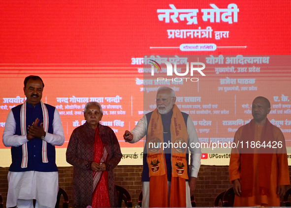 Indian Prime Minister Narendra Modi (C) and Uttar Pradesh Chief Minister Yogi Adityanath attend the inauguration of various development proj...