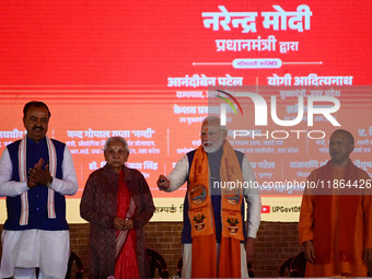 Indian Prime Minister Narendra Modi (C) and Uttar Pradesh Chief Minister Yogi Adityanath attend the inauguration of various development proj...