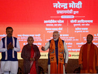 Indian Prime Minister Narendra Modi (C) and Uttar Pradesh Chief Minister Yogi Adityanath attend the inauguration of various development proj...