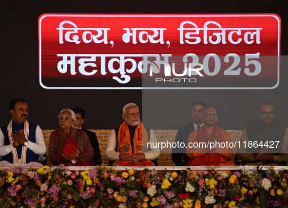 Indian Prime Minister Narendra Modi (C) and Uttar Pradesh Chief Minister Yogi Adityanath attend the inauguration of various development proj...