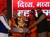 Uttar Pradesh Chief Minister Yogi Adityanath presents a statue of Ganga during the inauguration of various development projects for the '202...