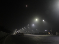 Street Lights Are Seen In The Fog Weather As Cold Waves Continues In The Eastern Parts Of India And Maximum Homeless People Are Facing Their...