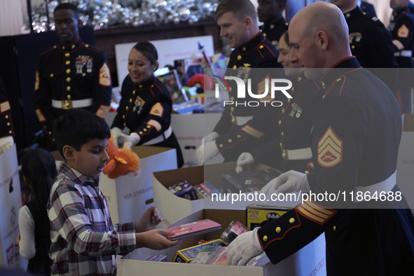 The First Lady Jill Biden holds a U.S. Marine Corps Reserve Toys for Tots event with local Marine Corps families in the East Room of the Whi...