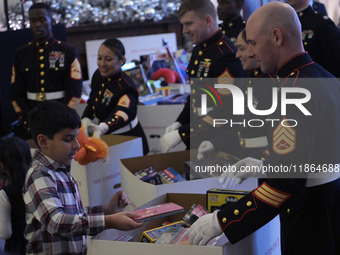 The First Lady Jill Biden holds a U.S. Marine Corps Reserve Toys for Tots event with local Marine Corps families in the East Room of the Whi...