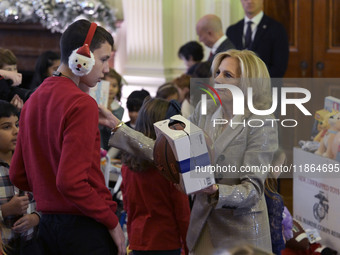 The First Lady Jill Biden holds a U.S. Marine Corps Reserve Toys for Tots event with local Marine Corps families in the East Room of the Whi...