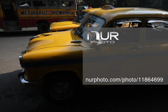 Taxi drivers wait for passengers with their iconic yellow Ambassador taxis in Kolkata, India, on December 13, 2024. The Calcutta High Court...