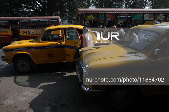 A passenger rides in an iconic yellow Ambassador taxi in Kolkata, India, on December 13, 2024. The Calcutta High Court orders that Kolkata's...