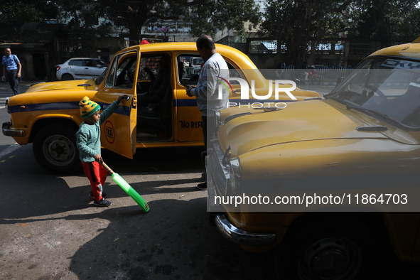 Passengers ride in an iconic yellow Ambassador taxi in Kolkata, India, on December 13, 2024. The Calcutta High Court's 2008 order states tha...