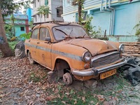 An abandoned iconic yellow Ambassador taxi is seen in Kolkata, India, on December 13, 2024. The Calcutta High Court orders that Kolkata's ic...