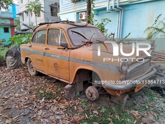 An abandoned iconic yellow Ambassador taxi is seen in Kolkata, India, on December 13, 2024. The Calcutta High Court orders that Kolkata's ic...