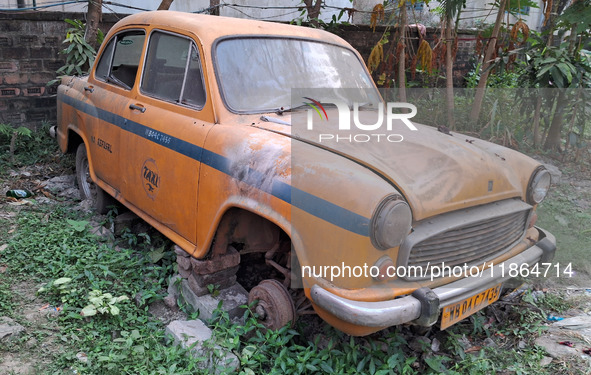 An abandoned iconic yellow Ambassador taxi is seen in Kolkata, India, on December 13, 2024. The Calcutta High Court orders that Kolkata's ic...