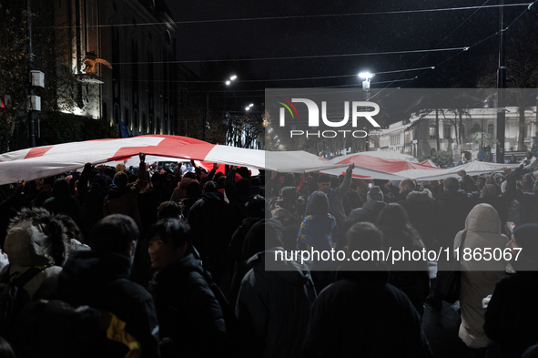 Anti-government protesters demonstrate against the Georgian government's postponement of European Union accession talks until 2028, in Tbili...