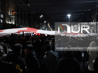 Anti-government protesters demonstrate against the Georgian government's postponement of European Union accession talks until 2028, in Tbili...