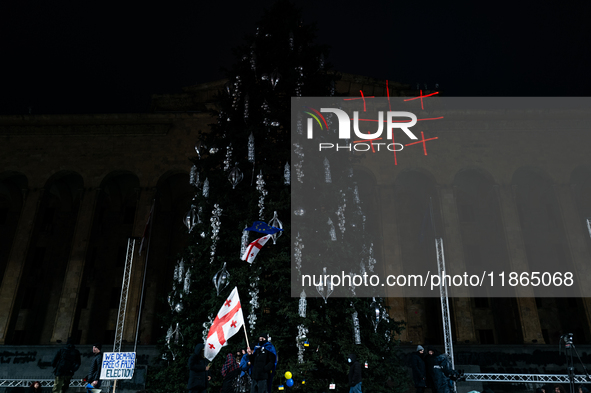 Anti-government protesters demonstrate against the Georgian government's postponement of European Union accession talks until 2028, in Tbili...