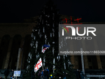 Anti-government protesters demonstrate against the Georgian government's postponement of European Union accession talks until 2028, in Tbili...