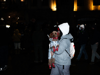 An anti-government protester holds a dog during a demonstration against the Georgian government's postponement of European Union accession t...