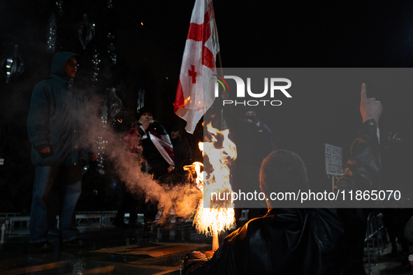 Anti-government protesters demonstrate against the Georgian government's postponement of European Union accession talks until 2028, in Tbili...