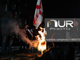 Anti-government protesters demonstrate against the Georgian government's postponement of European Union accession talks until 2028, in Tbili...