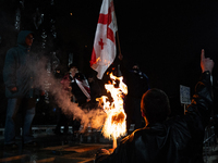 Anti-government protesters demonstrate against the Georgian government's postponement of European Union accession talks until 2028, in Tbili...