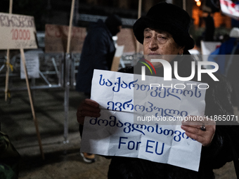 Anti-government protesters demonstrate against the Georgian government's postponement of European Union accession talks until 2028, in Tbili...