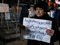 Anti-government protesters demonstrate against the Georgian government's postponement of European Union accession talks until 2028, in Tbili...