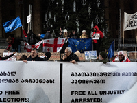 Anti-government protesters demonstrate against the Georgian government's postponement of European Union accession talks until 2028, in Tbili...