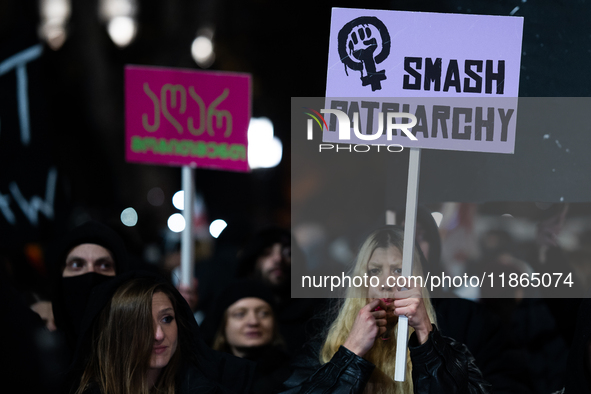 Anti-government protesters demonstrate against the Georgian government's postponement of European Union accession talks until 2028, in Tbili...