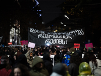 Anti-government protesters demonstrate against the Georgian government's postponement of European Union accession talks until 2028, in Tbili...