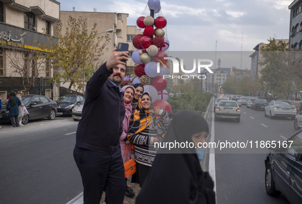 An Iranian family takes a selfie with Christmas decorations put up by the municipality of District Six while Christmas shopping in downtown...