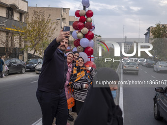 An Iranian family takes a selfie with Christmas decorations put up by the municipality of District Six while Christmas shopping in downtown...