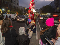 Two young Iranian women pose for a photograph with Christmas decorations put up by the municipality of District Six while Christmas shopping...