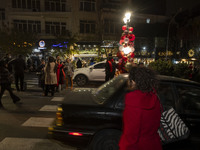 Young Iranian women pose for a photograph with Christmas decorations put up by the municipality of District Six while Christmas shopping in...