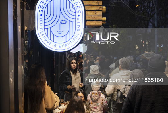 A young Iranian woman stands outside a cafe during Christmas shopping in downtown Tehran, Iran, on December 13, 2024. While Iranian-Christia...