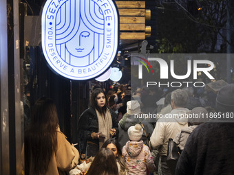 A young Iranian woman stands outside a cafe during Christmas shopping in downtown Tehran, Iran, on December 13, 2024. While Iranian-Christia...