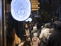 A young Iranian woman stands outside a cafe during Christmas shopping in downtown Tehran, Iran, on December 13, 2024. While Iranian-Christia...