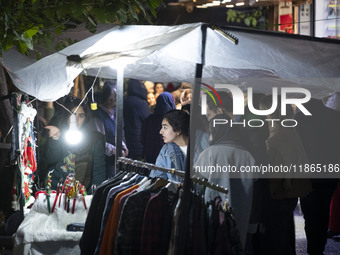 A young Iranian woman shops for Christmas accessories from a vendor in downtown Tehran, Iran, on December 13, 2024. Iranian-Christians celeb...