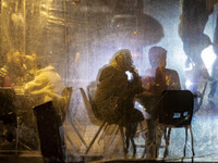 Iranian people sit at an outdoor cafe during Christmas shopping in downtown Tehran, Iran, on December 13, 2024. While Iranian-Christians cel...