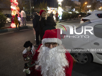 An Iranian-Christian man dressed as Santa Claus sits on a street-side during Christmas shopping in downtown Tehran, Iran, on December 13, 20...