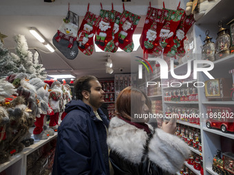 An Iranian-Christian couple looks at Christmas accessories while shopping for Christmas at a shop in downtown Tehran, Iran, on December 13,...