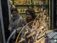 Two young Iranian women walk past Christmas accessories during Christmas shopping in downtown Tehran, Iran, on December 13, 2024. While Iran...